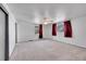 Spacious carpeted bedroom, featuring neutral walls, two windows with dark red curtains, and a ceiling fan at 3792 S Fenton Way, Denver, CO 80235