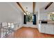 Dining area with chandelier, open layout, and a view to the white kitchen at 3792 S Fenton Way, Denver, CO 80235
