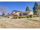 Charming two-story home with brick accents, lush landscaping, and a well-manicured front yard at 3792 S Fenton Way, Denver, CO 80235