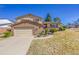 Two-story home with a brick and siding exterior, a driveway, and a well-manicured front lawn at 3792 S Fenton Way, Denver, CO 80235