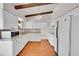 Bright, updated kitchen featuring white cabinets, modern appliances, and ample counter space at 3792 S Fenton Way, Denver, CO 80235