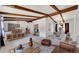 Staged living room with exposed beams and an open floor plan concept at 3792 S Fenton Way, Denver, CO 80235