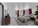 Staged main bedroom features stylish decor, including a ceiling fan, carpet, bed, and matching bedside tables at 3792 S Fenton Way, Denver, CO 80235