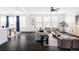 Spacious living room with ample natural light, dark floors, and stylish contemporary furniture at 15977 Red Bud Dr, Parker, CO 80134