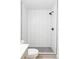Modern shower with white subway tile and contrasting gray penny tile flooring at 15977 Red Bud Dr, Parker, CO 80134