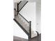 Elegant staircase with dark wood railings and carpeted steps leads to the upper level of the home at 15977 Red Bud Dr, Parker, CO 80134