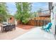 Spacious backyard with a stone patio, wooden fence, and lush greenery at 2211 W 33Rd Ave, Denver, CO 80211