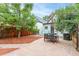 Charming backyard featuring a stone patio, outdoor seating, and lush landscaping at 2211 W 33Rd Ave, Denver, CO 80211