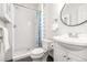 Clean bathroom featuring a tiled shower with glass enclosure, modern vanity, and stylish fixtures at 2211 W 33Rd Ave, Denver, CO 80211
