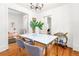 Bright and airy dining room with hardwood floors, stylish decor, and a doorway into another room at 2211 W 33Rd Ave, Denver, CO 80211