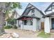 Exterior view of a charming two-story home with grey paint, black trim and a quaint front porch at 2211 W 33Rd Ave, Denver, CO 80211