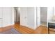 Hallway with hardwood floors and doors that lead to other rooms at 2211 W 33Rd Ave, Denver, CO 80211