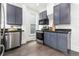 Well-equipped kitchen with stainless steel appliances, dark cabinetry, and granite countertops at 2211 W 33Rd Ave, Denver, CO 80211