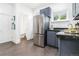 Spacious kitchen featuring stainless steel refrigerator, granite countertops, and tiled floors at 2211 W 33Rd Ave, Denver, CO 80211