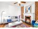 Inviting living room featuring a decorative fireplace, wood floors, comfortable seating, and neutral decor at 2211 W 33Rd Ave, Denver, CO 80211