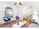 Bright living room with hardwood floors, modern chairs, large windows, and a view of the stairway at 2211 W 33Rd Ave, Denver, CO 80211