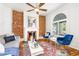 Cozy living room showcasing exposed brick, decorative fireplace, hardwood floors, and comfortable blue furniture at 2211 W 33Rd Ave, Denver, CO 80211
