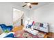 Bright living room with hardwood floors, a comfortable gray sofa, and a view into the stairway at 2211 W 33Rd Ave, Denver, CO 80211