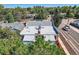 Birds-eye view, showcasing a roof with chimney, skylights and street traffic in a tree lined street at 493 S Lincoln St, Denver, CO 80209