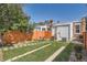 A fenced backyard with a seating area and a pathway of stepping stones through the grass at 493 S Lincoln St, Denver, CO 80209
