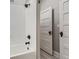 Bright white bathroom with white subway tile, sleek hardware, and white painted doors at 493 S Lincoln St, Denver, CO 80209