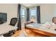 Comfortable bedroom with hardwood floors, natural light, and desk space offers a relaxing atmosphere at 493 S Lincoln St, Denver, CO 80209