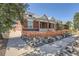 Charming brick home with a manicured front yard, showcasing a unique stone border along the sidewalk at 493 S Lincoln St, Denver, CO 80209