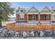 Charming brick home with a well-manicured front yard, framed by a wooden fence and unique stone border at 493 S Lincoln St, Denver, CO 80209