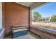 Inviting front porch featuring a wooden bench, brick wall, and a glimpse of the neighborhood street at 493 S Lincoln St, Denver, CO 80209