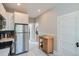 Contemporary kitchen with stainless steel appliances, white cabinets, and tiled floors at 493 S Lincoln St, Denver, CO 80209