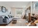 Sun-filled living room featuring a fireplace, stylish seating, and a view from the decorative window at 493 S Lincoln St, Denver, CO 80209