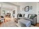 Open living space with hardwood floors, a modern sofa, and a view into the dining room at 493 S Lincoln St, Denver, CO 80209
