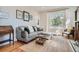 Cozy living room with a comfortable sofa, decorative art, and natural light at 493 S Lincoln St, Denver, CO 80209