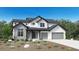 New construction home showcasing a modern farmhouse design with stone accents, board and batten siding, and a two-car garage at 5851 Las Rosas Dr, Parker, CO 80134