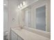 Bathroom with bright lighting over vanity and a large mirror for grooming, with a partial view of the shower at 13770 Emerald Lake St, Parker, CO 80138