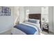 Bright bedroom featuring a plush bed, stylish furniture, and an adjacent bathroom, creating a serene retreat at 13770 Emerald Lake St, Parker, CO 80138