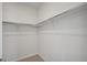 Walk-in closet with ample storage space with metal rods for hanging clothing at 13770 Emerald Lake St, Parker, CO 80138