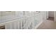 Bright hallway featuring white railings, carpeted floors, and natural light offering seamless transition between spaces at 13770 Emerald Lake St, Parker, CO 80138