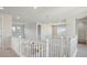 Upstairs hallway with white railings and neutral walls providing an airy, bright passage to different areas of the house at 13770 Emerald Lake St, Parker, CO 80138
