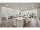 Spacious open-concept kitchen with a large island, stainless steel appliances, and modern lighting at 13770 Emerald Lake St, Parker, CO 80138