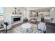 Comfortable living area with fireplace and stylish decor, seamlessly connected to a modern kitchen at 13770 Emerald Lake St, Parker, CO 80138