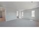 Spacious living room with large windows and neutral carpeting at 13770 Emerald Lake St, Parker, CO 80138