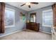 Bedroom with dresser, large windows, and ceiling fan at 2799 Syracuse Ct, Denver, CO 80238