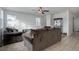 Living room with brown couches and a ceiling fan at 2799 Syracuse Ct, Denver, CO 80238