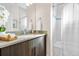 Modern bathroom with a vanity, a stylish mirror, and a shower with a curtain at 2321 Eliot St, Denver, CO 80211