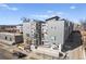 Modern building exterior with gray and white panels, balconies, and clean architectural lines at 2321 Eliot St, Denver, CO 80211