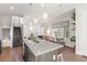 Open kitchen with center island and barstool seating flows into dining and living areas at 2321 Eliot St, Denver, CO 80211
