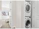 Convenient laundry area featuring stacked washer and dryer units near the bedroom at 2321 Eliot St, Denver, CO 80211