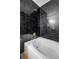 A luxurious bathtub is surrounded by elegant black marble walls and gold fixtures at 201 Wright St # 106, Lakewood, CO 80228