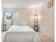 Bedroom featuring plush carpet, a window with curtains, and a modern floor lamp at 201 Wright St # 106, Lakewood, CO 80228